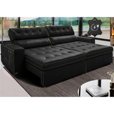 a living room with a black leather couch and coffee table