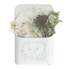 a white box filled with flowers and pictures