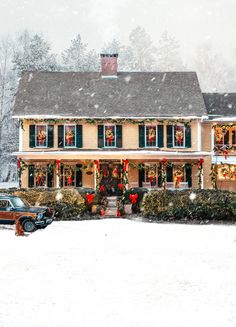 a house with christmas decorations and lights on it's front porch in the snow