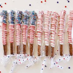 red, white and blue candy sticks are lined up