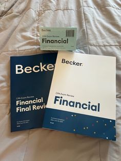 two financial books are laying on a bed