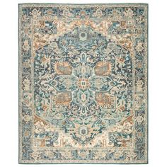 a blue and beige rug with an ornate design on the center, in front of a white background