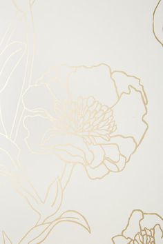 a white and gold wallpaper with flowers on it