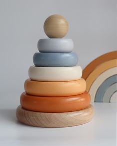 a stack of colorful wooden toys sitting on top of a white table