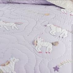 an image of a bed with unicorns on it in the day light colors and stars