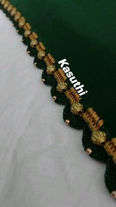 the green fabric has gold trim around it