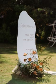 a memorial stone with flowers in the foreground