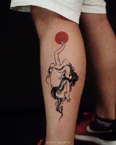 a tattoo on the leg of a person with a red sun in the sky behind her