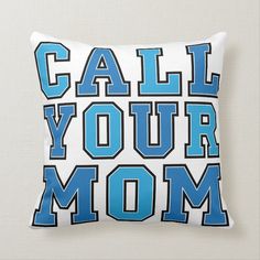 a pillow with the words call your mom in blue and white on it's front