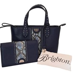 This Retired Hard To Find Navy Blue Small Tote And Organizer Set From Brighton's Pretty Tough Collection Is In Excellent Pre-Owned Condition. Both Feature A Python Racing Stripe And Silver Tone Stud Details. The Tote Has An Exterior Slip Pocket, 2 Interior Zip Pockets, 2 Interior Slip Pockets, Interior Key Clip, Interior Brighton Creed, And Exterior Brighton Hang Charm. All Zippers Function Flawlessly. The Organizer Has An Exterior Slip Pocket, 2 Interior Slip Pockets, 14 Card Slots, Id Pocket, Handbag Organizer, Brighton Bags, Handbag Organization, Key Clip, Racing Stripes, Wallet Organization, Tote Handbag, Small Tote, Navy Blue Color