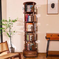 a tall book shelf with many books on it next to a chair and table in a room