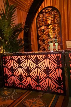 an elaborately designed bar in the middle of a room with orange drapes on it