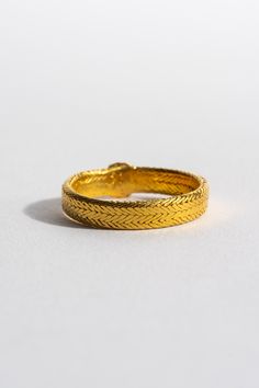 This intricately woven ring can be seamlessly dressed up or down. Wear it alone, or pair with your favorite gold pieces for a unique stack. 22K Yellow Gold Made in India Please note, this item is final sale. Bohemian Engraved Brass Bangle, Bohemian Brass Bangle Engraved, Vintage Gold Brass Bangle, Bohemian Carved Brass Jewelry, Vintage Bronze Brass Bangle, Garden Clogs, Woven Ring, Black Crane, Gold Piece