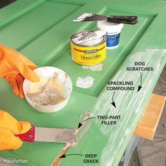 a person in yellow gloves is painting a green table with white paint and other tools