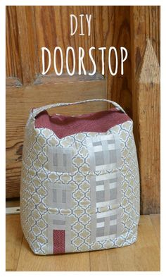 a small purse sitting on top of a wooden floor next to a door with the words diy doorstop written above it