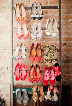 there are many pairs of shoes hanging on the wall