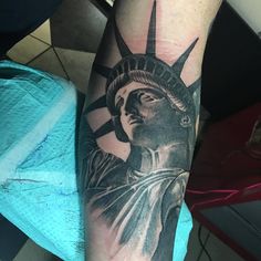 a statue of liberty tattoo on the arm