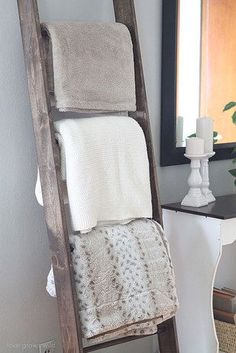 an old ladder is used as a towel rack