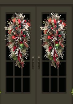 two double doors decorated with christmas decorations