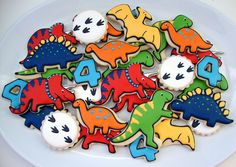 dinosaur cookies are arranged on a plate