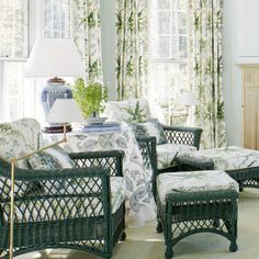 a living room with wicker furniture and green curtains