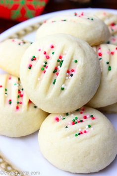 some cookies with sprinkles on a white plate