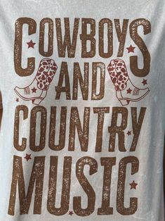 Cowboys and Country Music Mineral Washed T-Shirt 100% cotton mineral washed blush graphic t-shirt. This graphic t-shirt's design features the words, "COWBOYS AND COUNTRY MUSIC," in distressed, bold letters, along with a pair of cowboy boots and a sprinkling of star shapes throughout. This top is perfect for everyday wear! Sizing Hint: This is a basic unisex tee, which fits true to size. Care Instructions: Machine wash cold. Do not bleach. Tumble dry medium. Do not dry clean. Country T Shirts, Bold Letters, Cute N Country, Country Shirts, Shirt Ideas, Star Shape, Skirt Pants, Country Music, Shirt Jacket