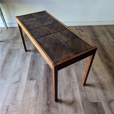 a wooden table sitting on top of a hard wood floor