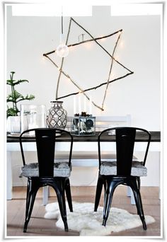 two black chairs sitting at a table in front of a star of david