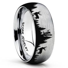 a black and white wedding ring with an image of trees on the inside of it