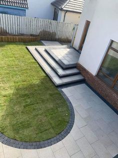 an outdoor patio with steps and grass