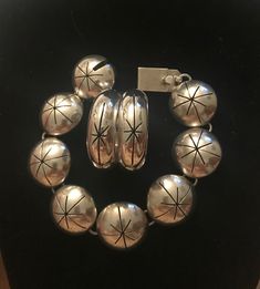 Taxco Mid century Modern Bracelet & earrings set.  Demi parure set.  Starburst design.  1950s 1960s. Space age.  Quintessentially MCM Mexico.  Bracelet: Measures 7 1/2" (7 1/4" wrist) Half dome hollow panels.  7/8" diameter.  Working secure clasp.  Slide in clasp.  Marked: TV-140 Mexico 925.  Hoop Earrings: Measure:  1 3/8" diameter.  1/2" width.  Pierced. French wire.  Marked: TM-159 Mexico 925.  Large but not weighty.  Statement pieces.  Previously owned.  Excellent vintage condition.  I polis Mid-century Handmade Formal Jewelry, Mid-century Polished Formal Jewelry, Nickel-free Retro Jewelry For Anniversary, Retro Nickel Free Jewelry For Anniversary, Vintage Silver Jewelry With Matching Earrings, Handmade Retro Silver Jewelry, Retro Formal Jewelry With Matching Earrings, Vintage Hoop Jewelry For Anniversary, Mid-century Bracelet Jewelry Gift