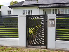 a white house with a black gate in front of it