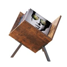 a wooden table with a magazine rack on it and an image of a man's face