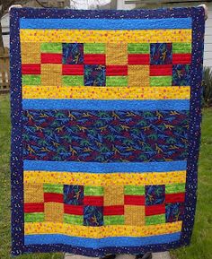 a quilted wall hanging in front of a house