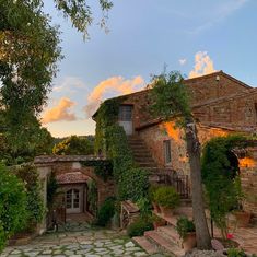 an old brick house with stone steps leading up to it