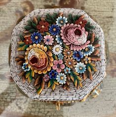 a basket with flowers painted on it