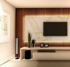 a living room with a flat screen tv mounted on the wall next to a plant