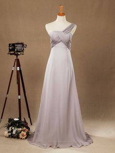 a dress on a mannequin next to a camera