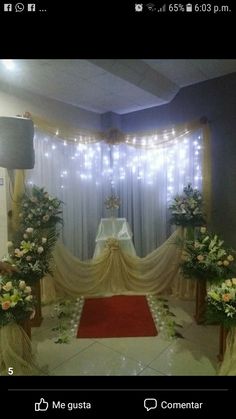 a room decorated with flowers and lights for a wedding or special occasion to be attended