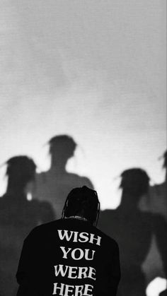 a man standing in front of a group of people with their shadows on the wall