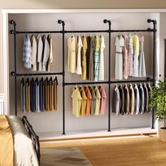 an open closet with clothes hanging on the wall