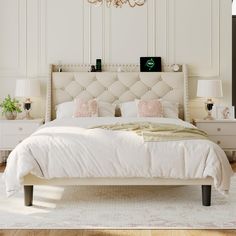 a white bed sitting in a bedroom on top of a hard wood floor