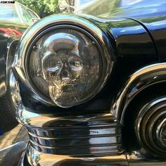 a skull headlight on the front of a classic car