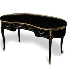 a black and gold desk with two drawers on one side, an oval mirror top table on the other