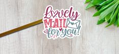 a sticker with the words lovely mail for you on it next to some green leaves