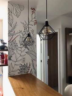 a kitchen with a wooden counter top and wallpaper