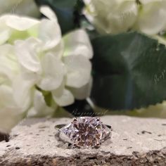 a diamond ring sitting on top of a stone