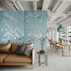 a living room filled with furniture and walls covered in blue mosaic tiles on the wall