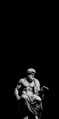 a black and white photo of a statue of a man with a beard sitting in front of a dark background